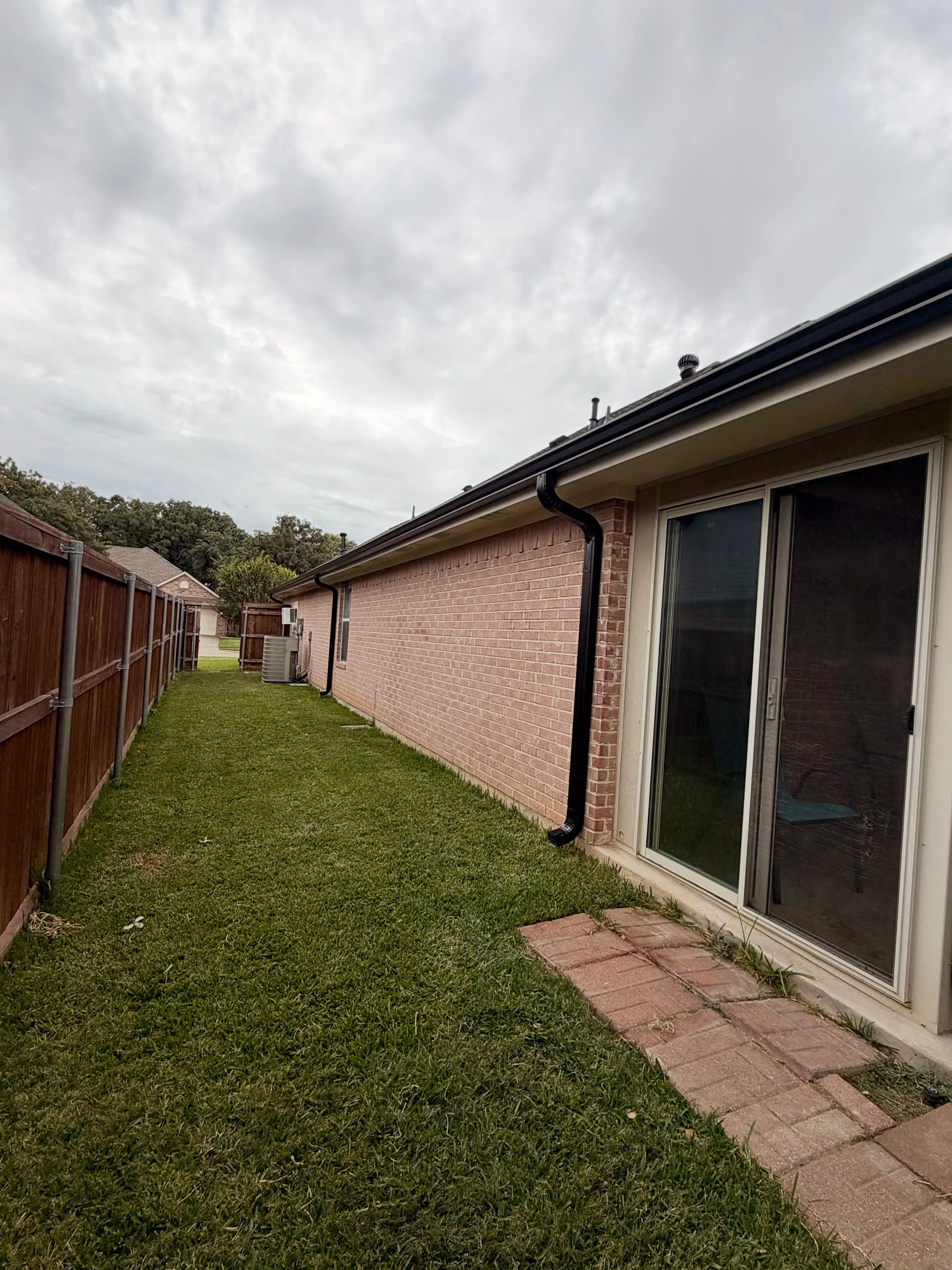 Gallery photos for Black Seamless Gutter Installation After Hail Damage in Burleson: Image #2