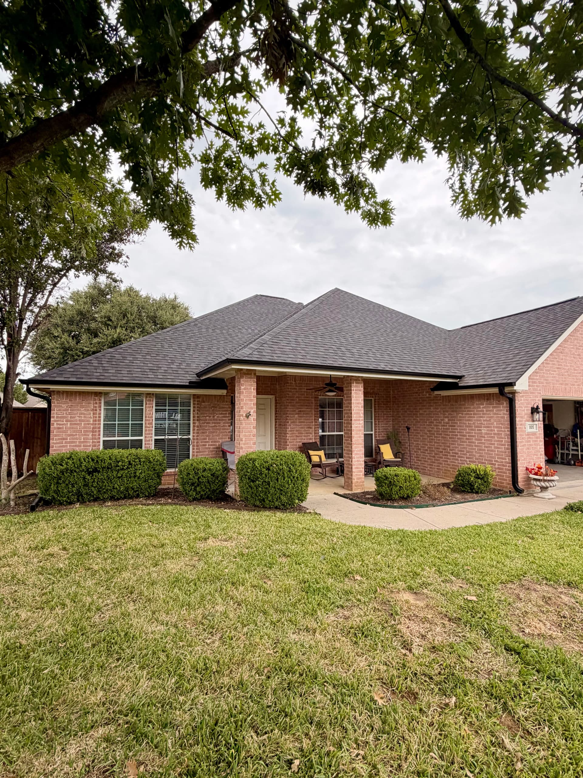 Black Seamless Gutter Installation After Hail Damage in Burleson image