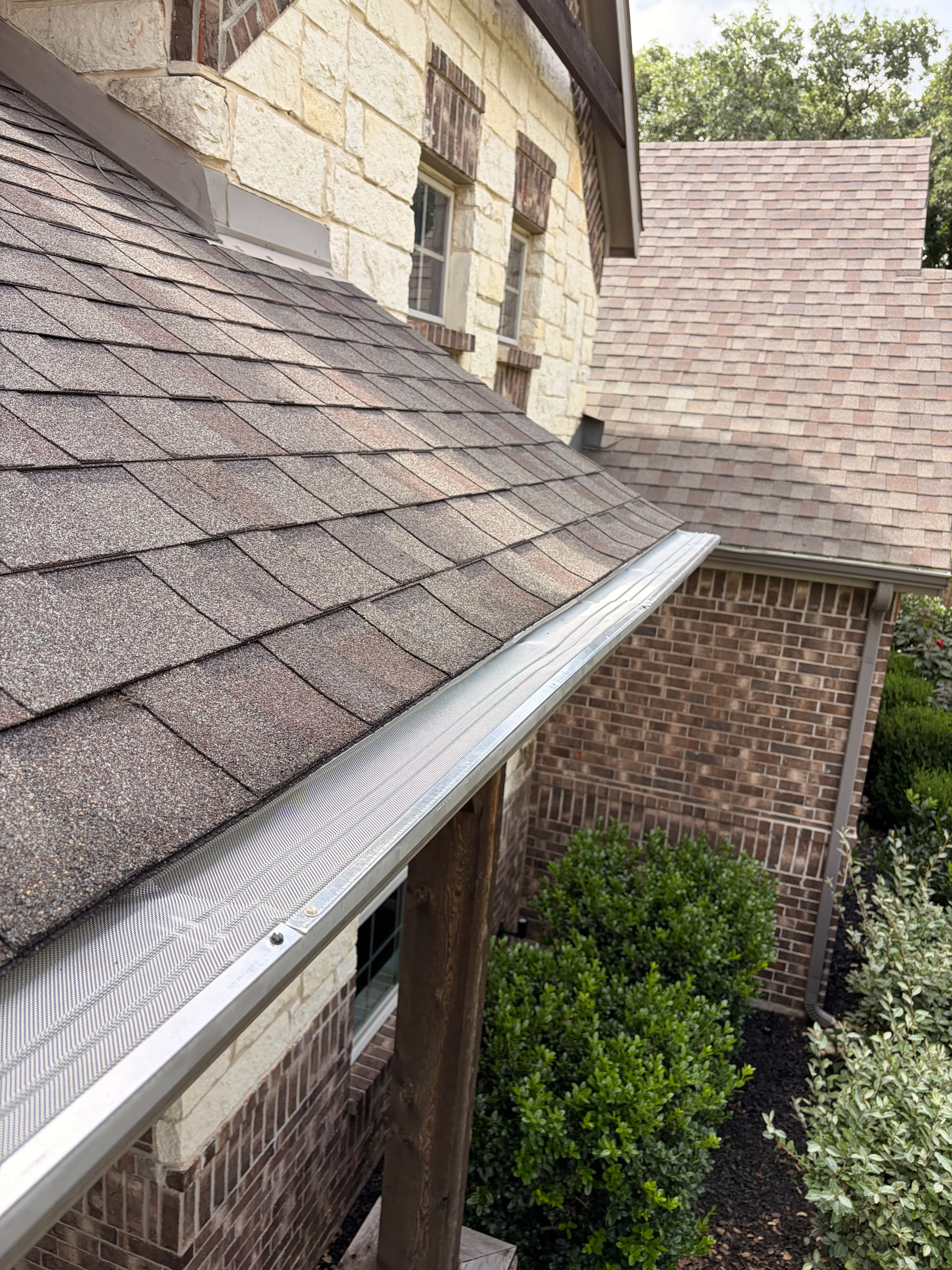 Project Premium Leaf Guards Installed on a Beautiful Stone and Brick Home image
