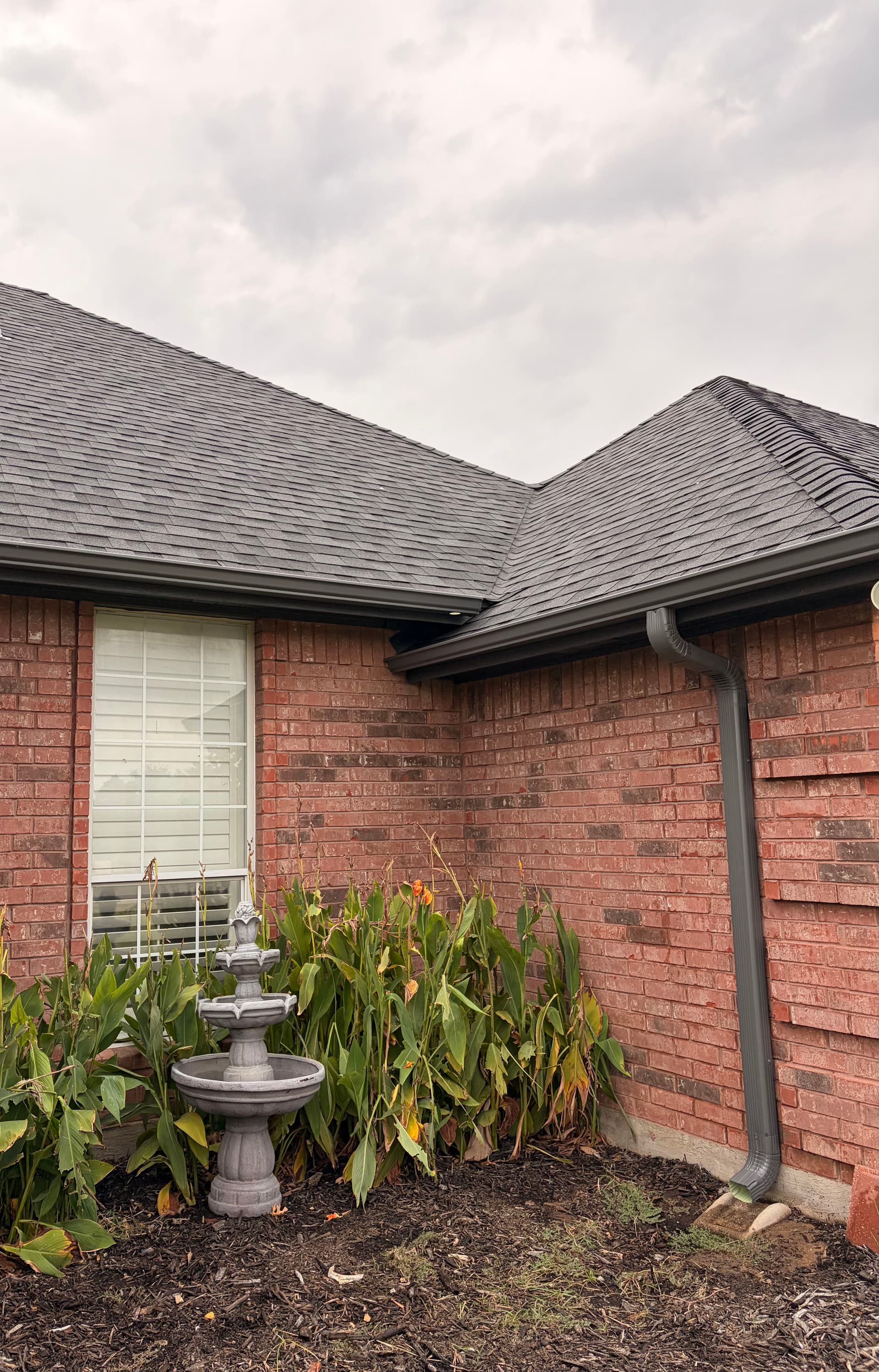 Tuxedo Gray 5-Inch Seamless Gutters on a Brick Home image
